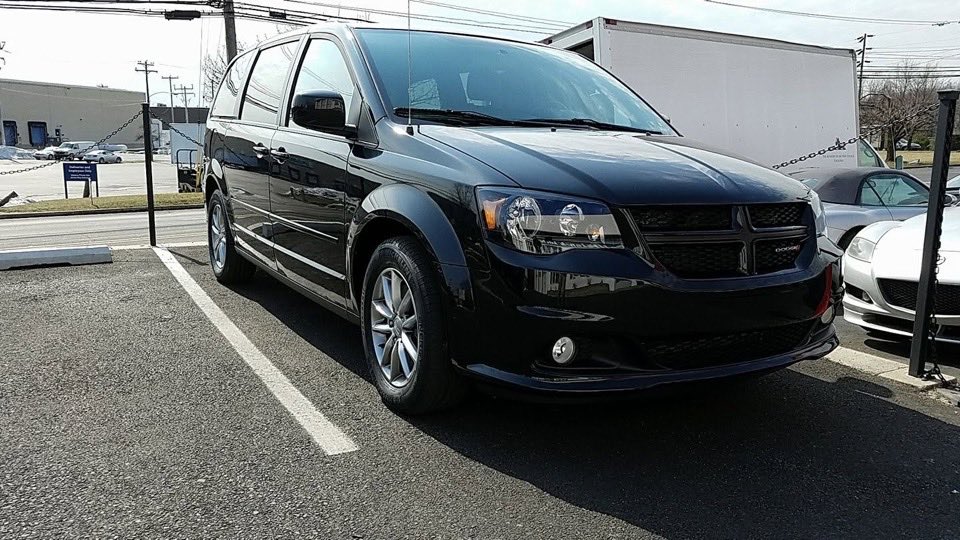 The same Dodge Grand Caravan after repair, with the front bumper, headlight and hood back in line.
