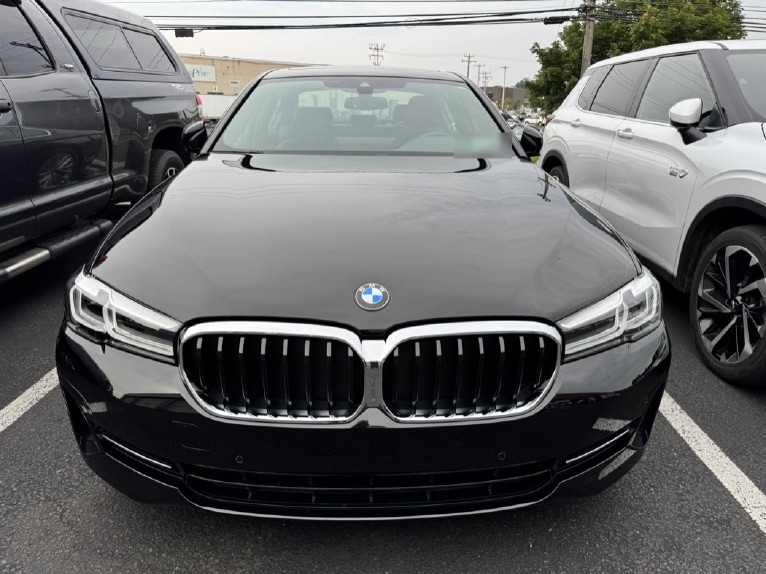 The same BMW 5 Series after repair, front bumper and grille aligned.