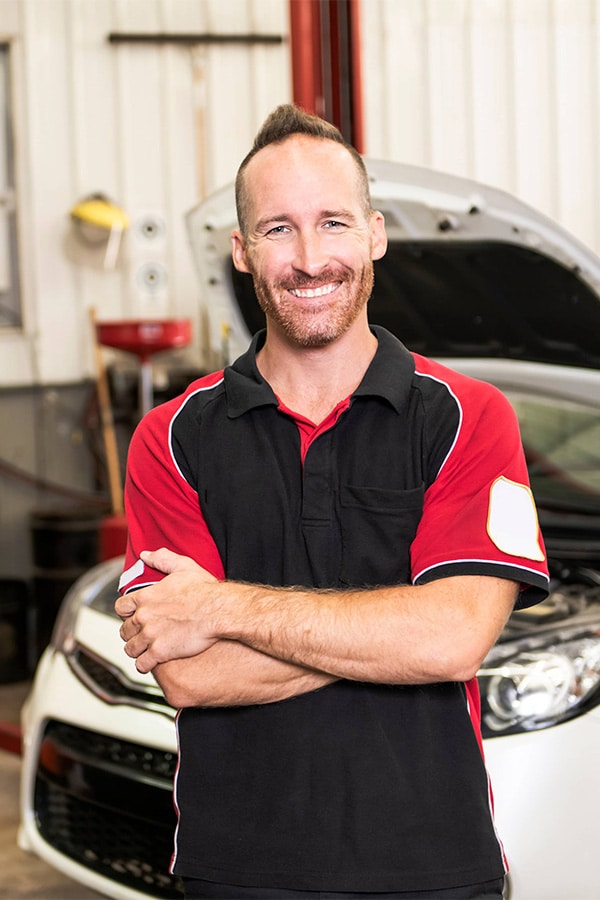 Auto shop employee smiling for the camera.