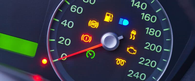 Vehicle indicator lights on a dashboard.